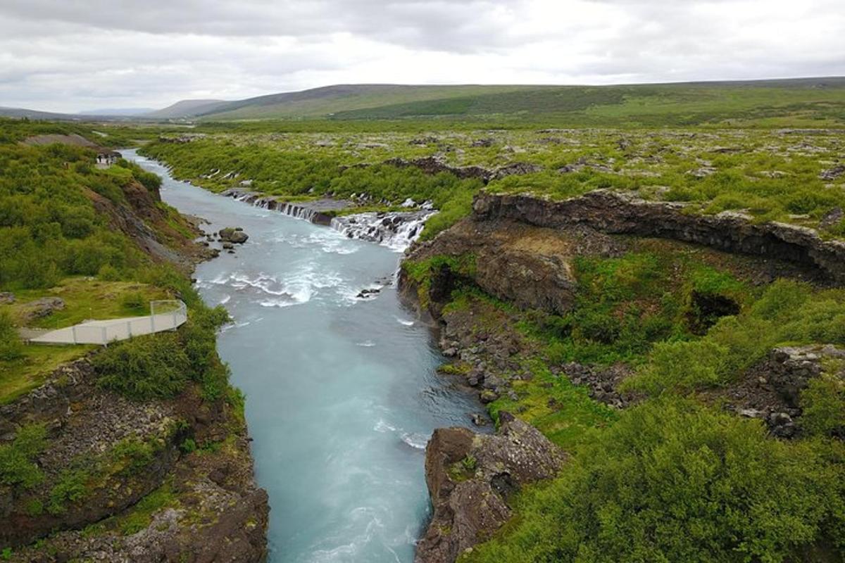 an aerial view of a river in a field