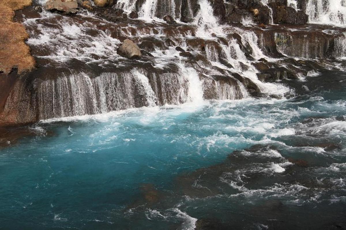 an aerial view of a river with waterfalls