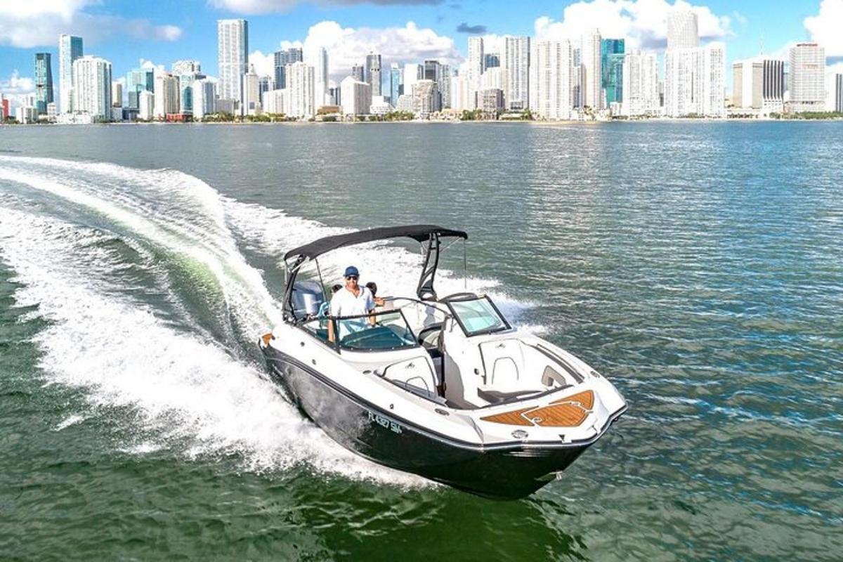 a man in a boat in the water with a city