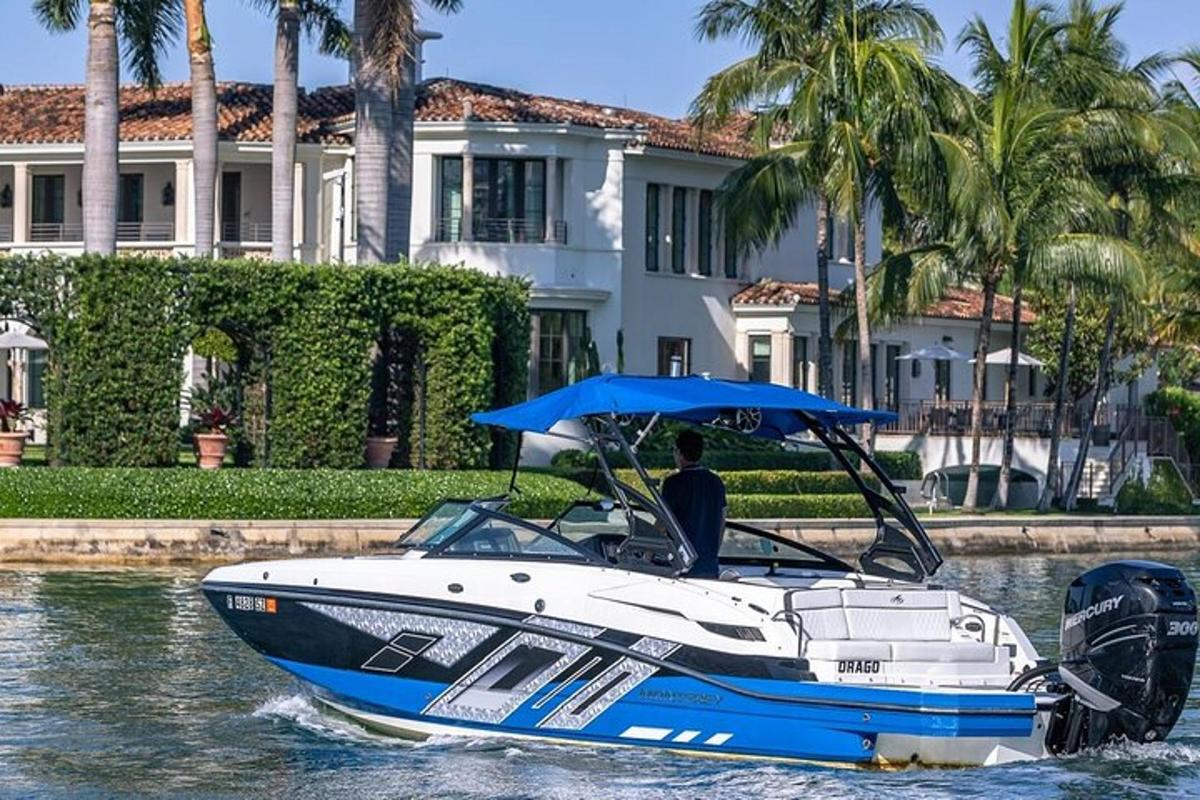 a man on a boat in the water in front of a house