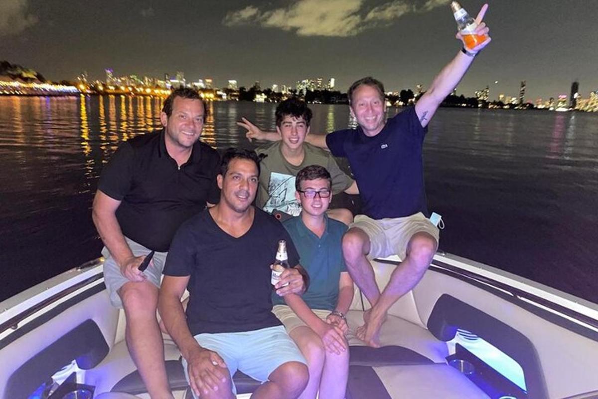 a group of men sitting on the back of a boat