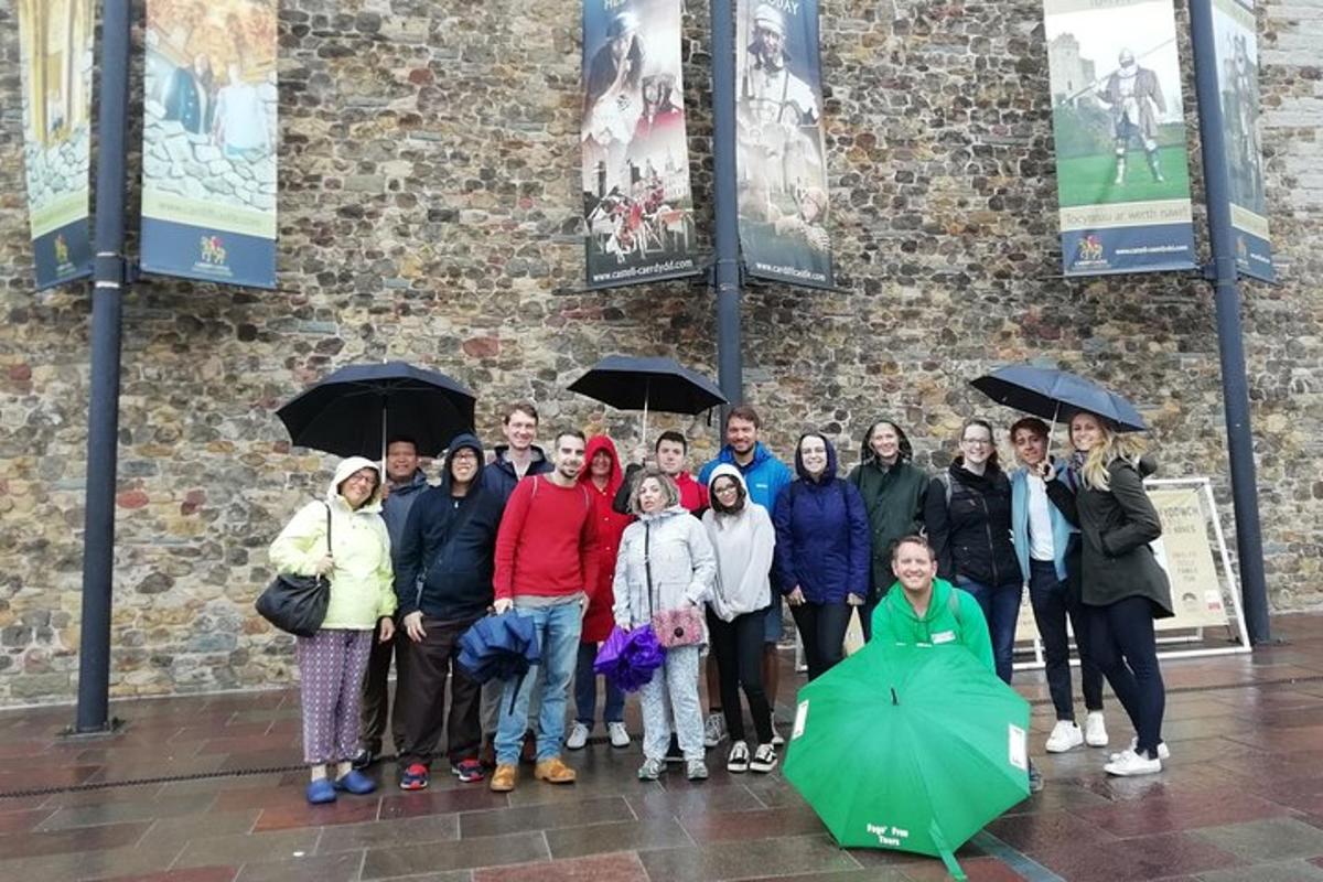 a group of people standing in the rain with umbrellas