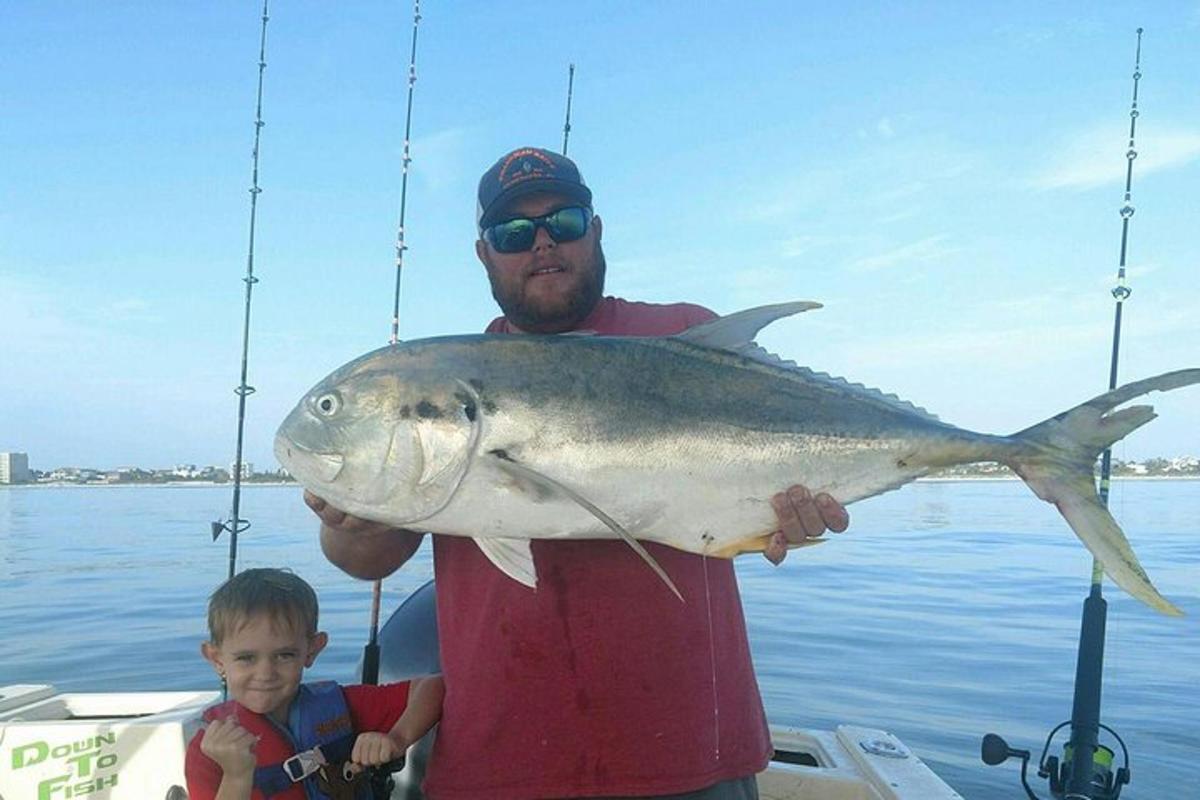 a man and a boy holding a large fish