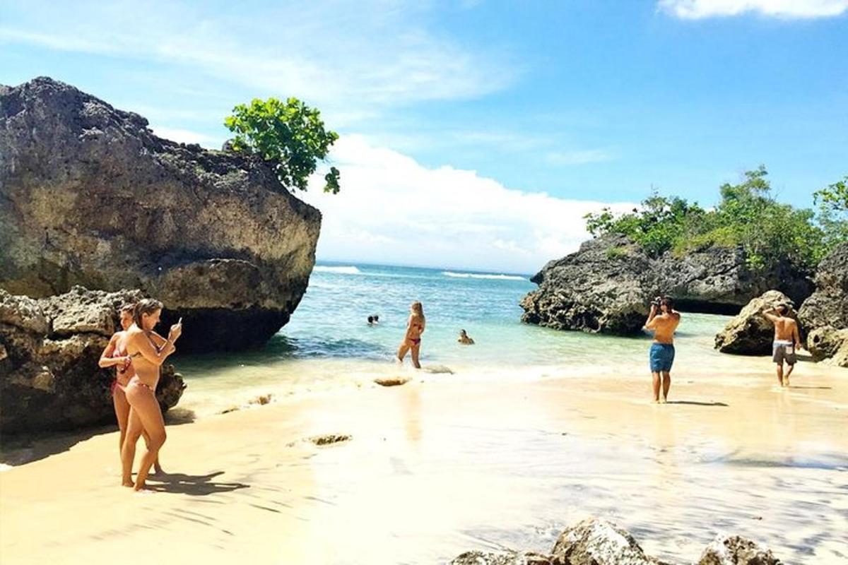 a group of people in the water on a beach