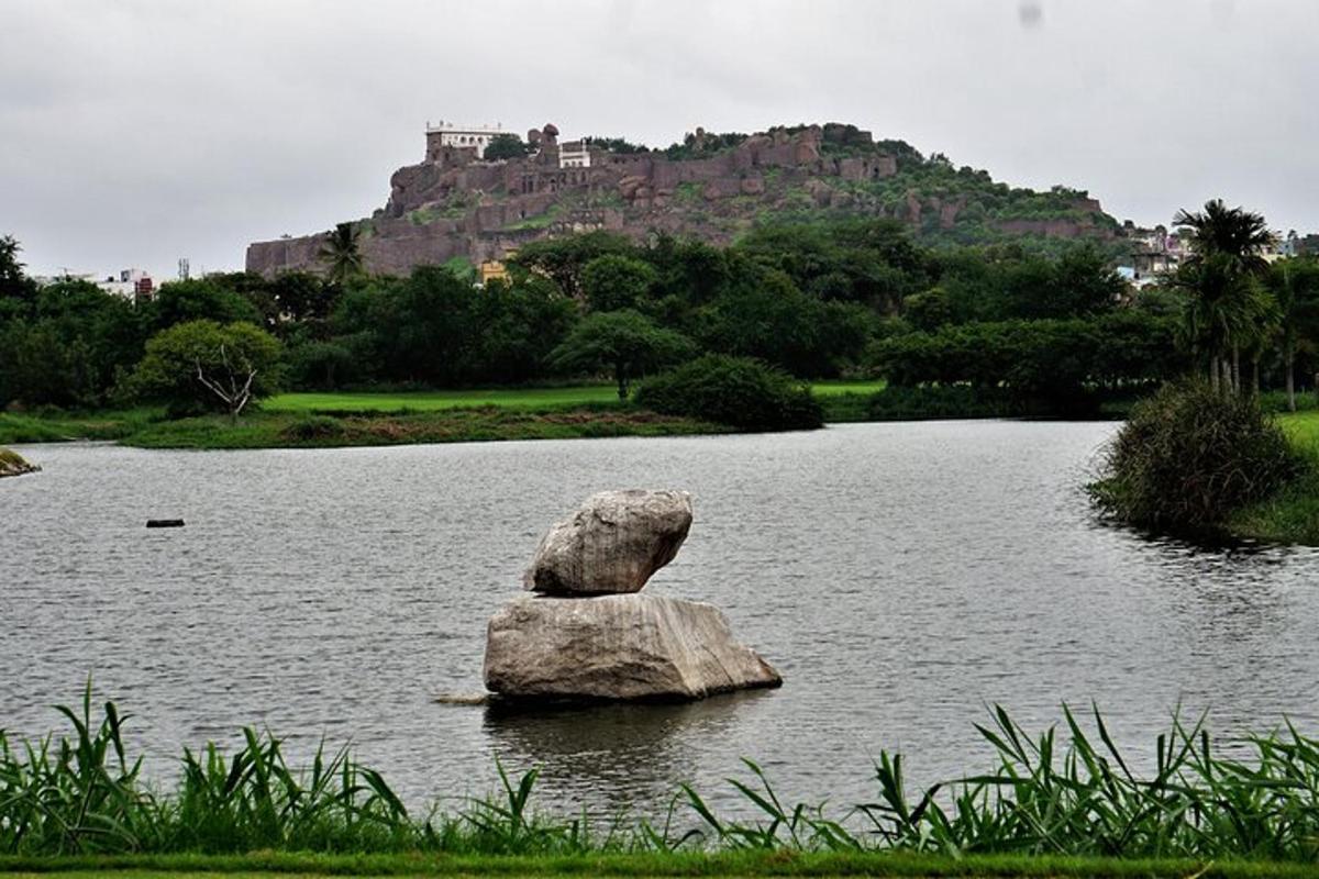 a rock sitting in the middle of a lake