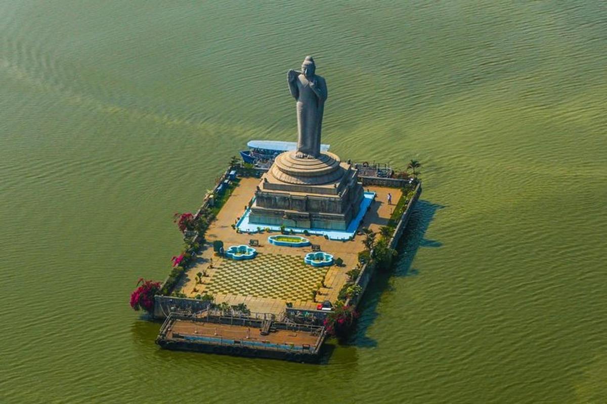 an aerial view of a statue in the water