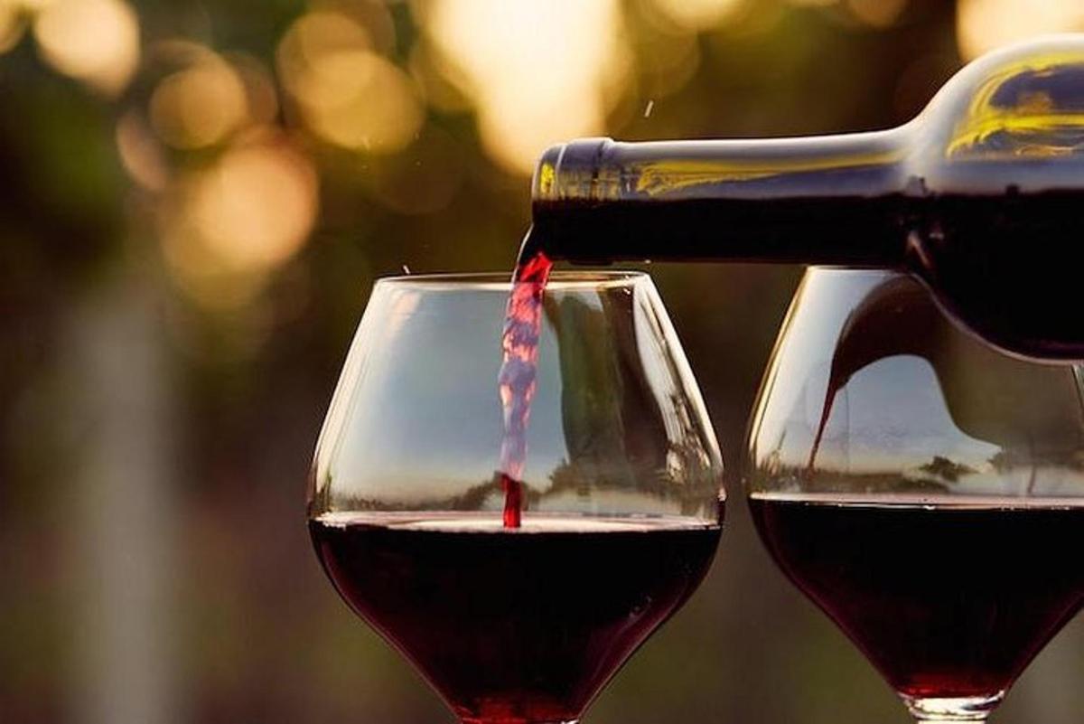 a bottle of wine being poured into a glass