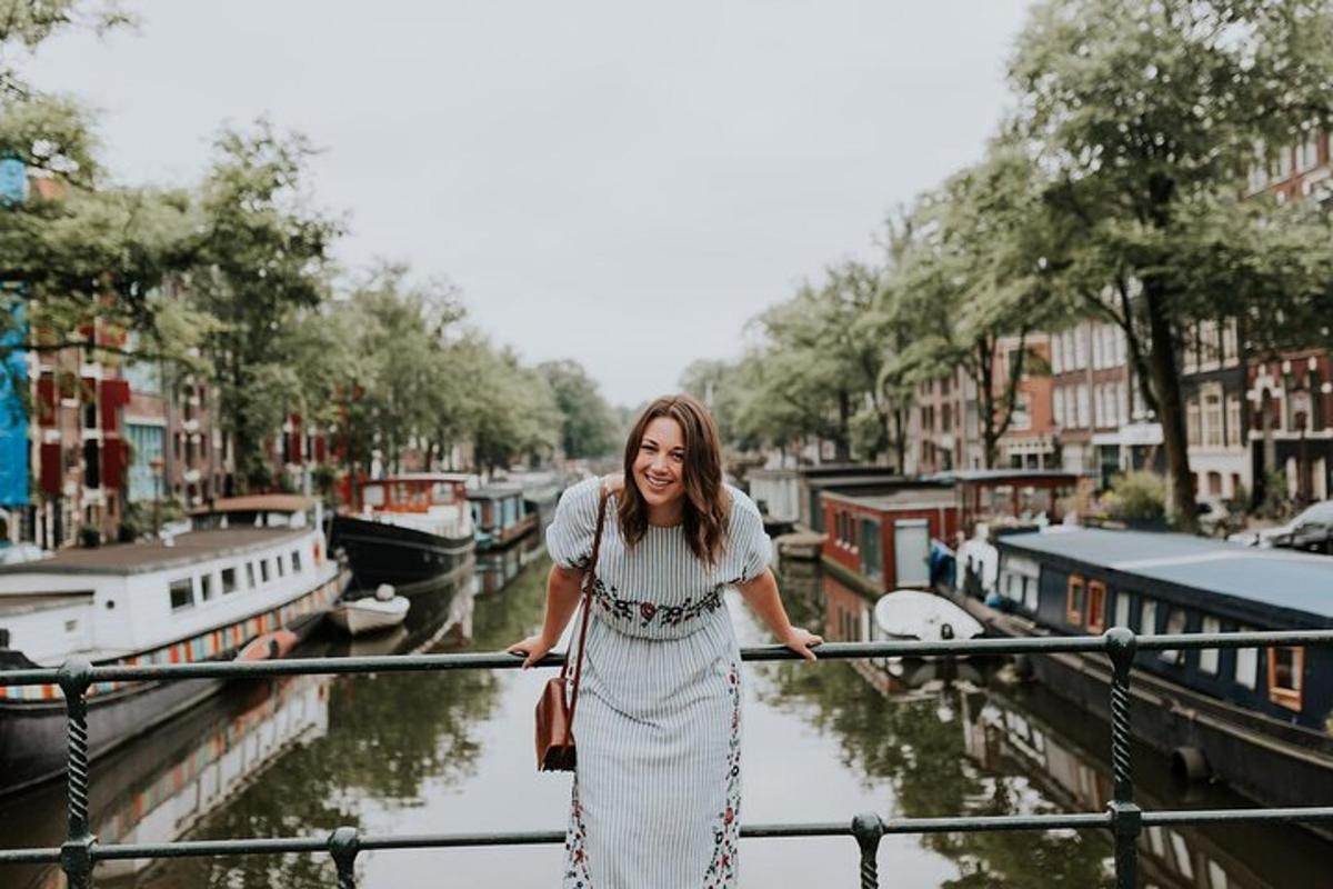 a woman in a white dress standing on a railing near a canal