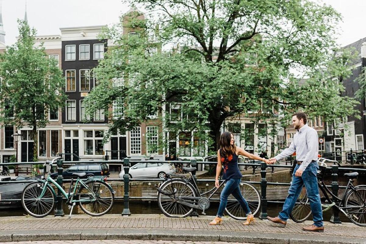 a man and a woman walking a bike on a street