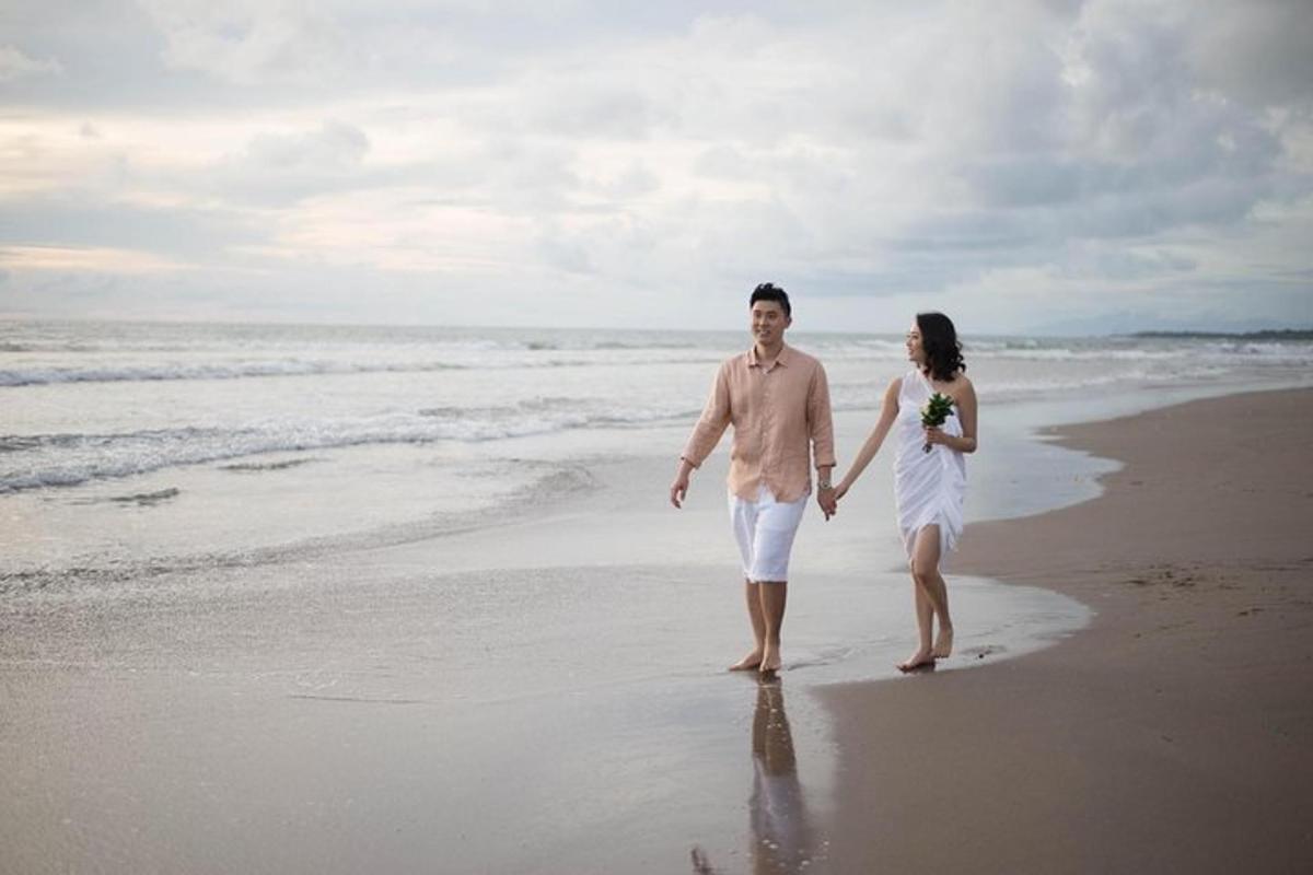 a man and a woman walking on the beach