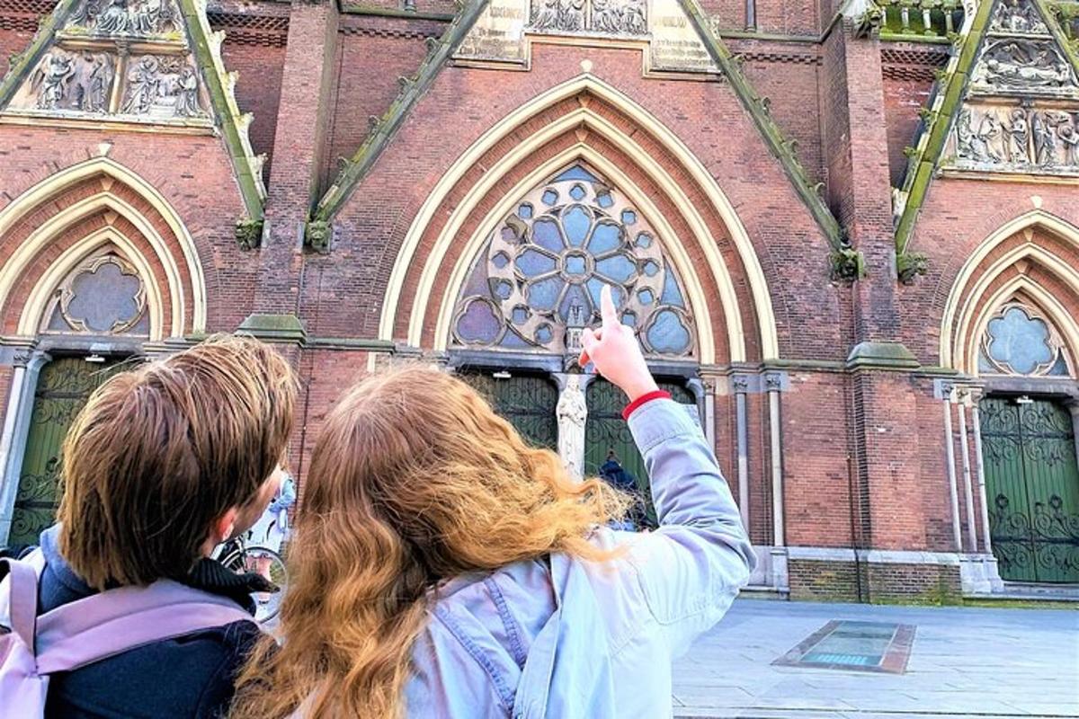 two women standing in front of a church