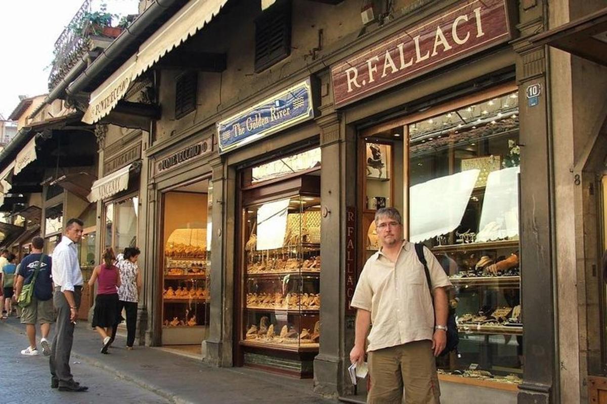 a man is standing in front of a bakery