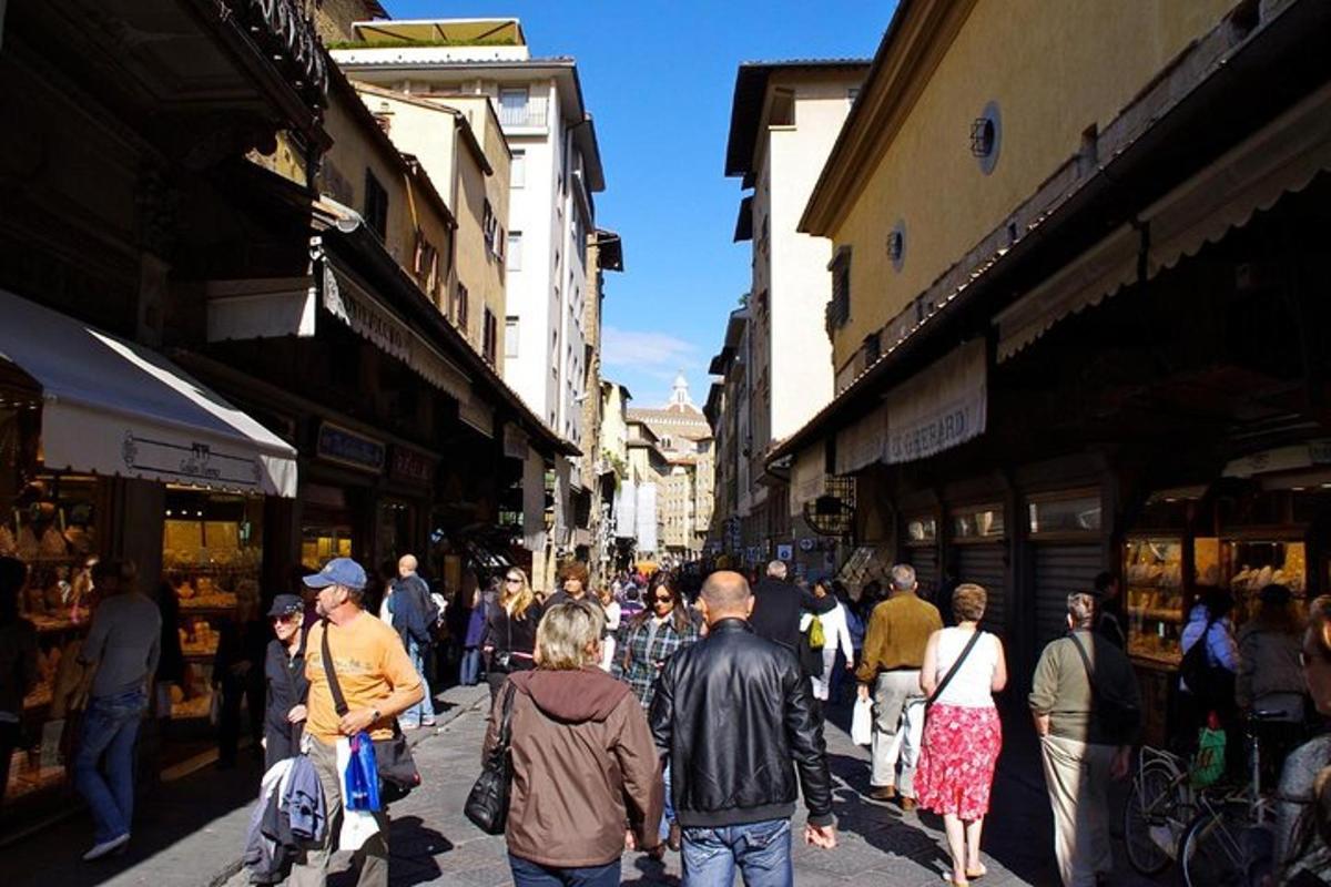 a crowd of people walking down a busy street