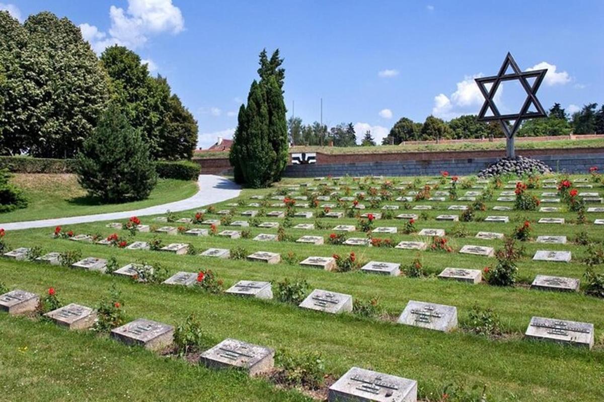 a cemetery with tombstones and flowers in a field