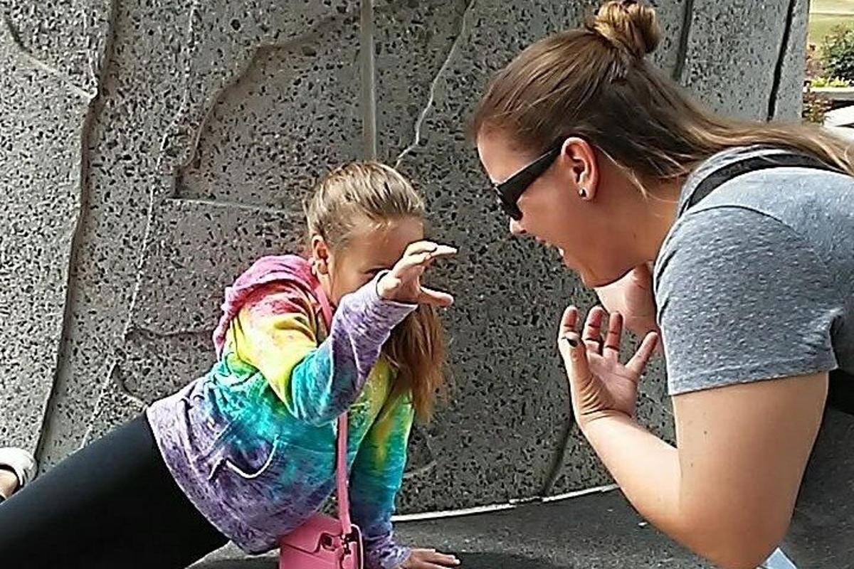a woman and a little girl pointing at something