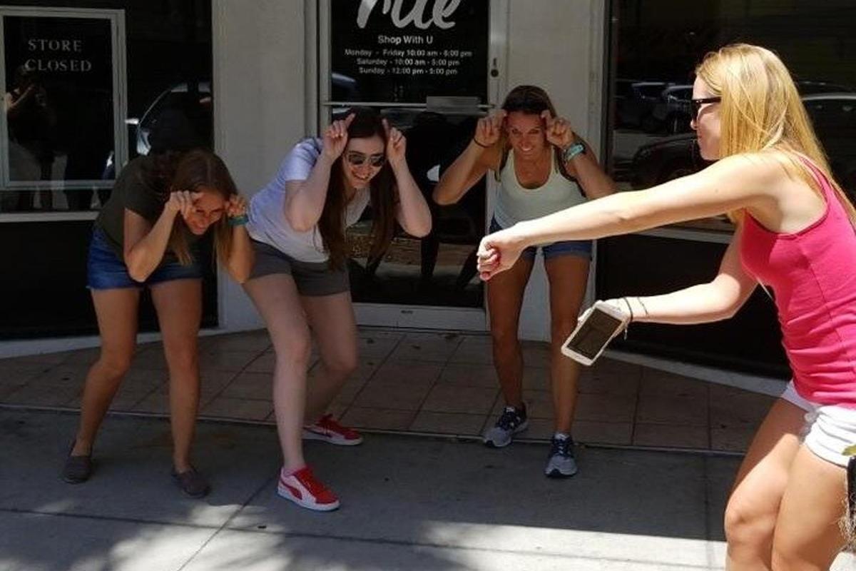 a group of girls standing in front of a store