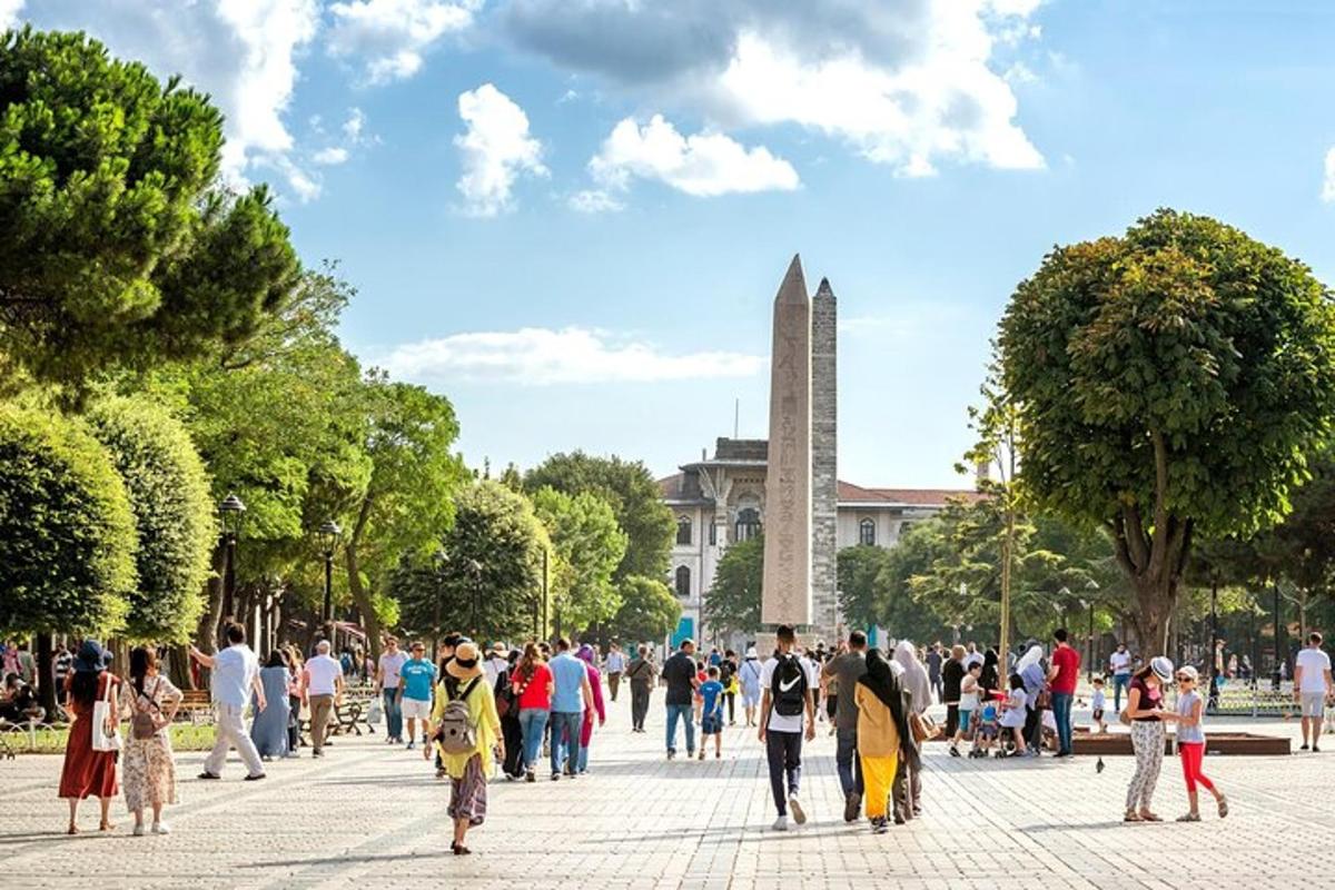 a crowd of people walking in front of a monument