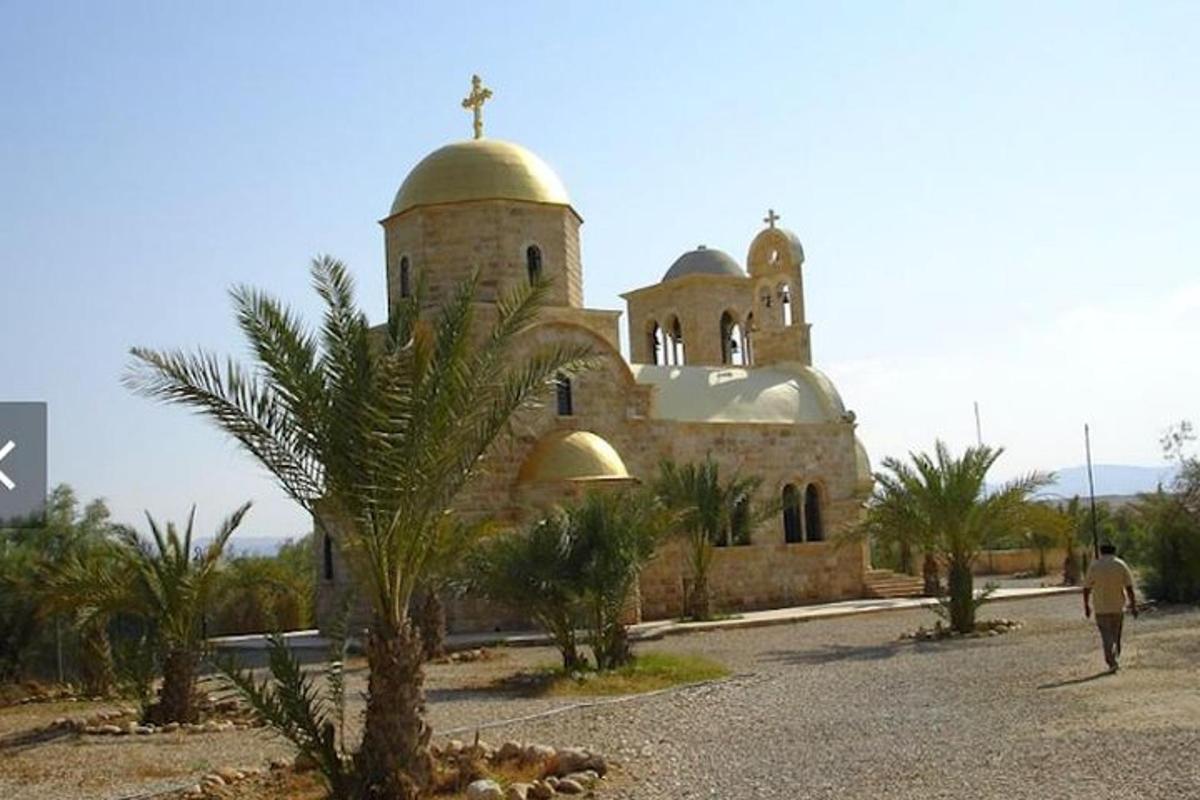 a church with a palm tree in front of it