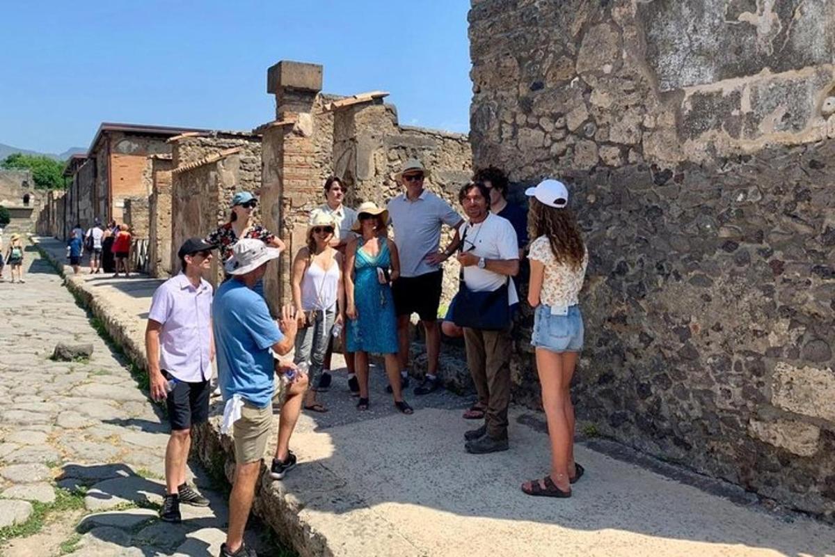 a group of people standing next to a wall