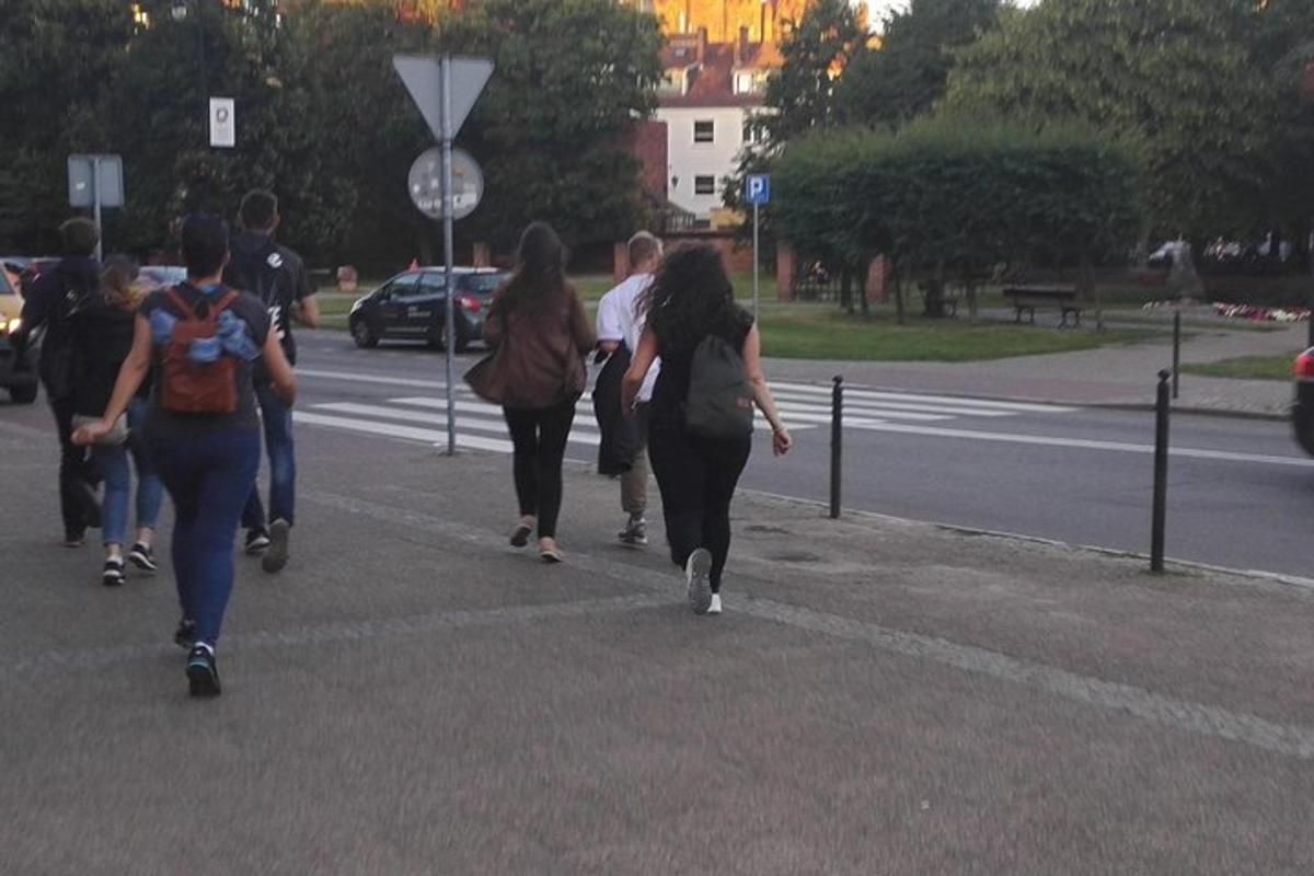 a group of people walking down a street