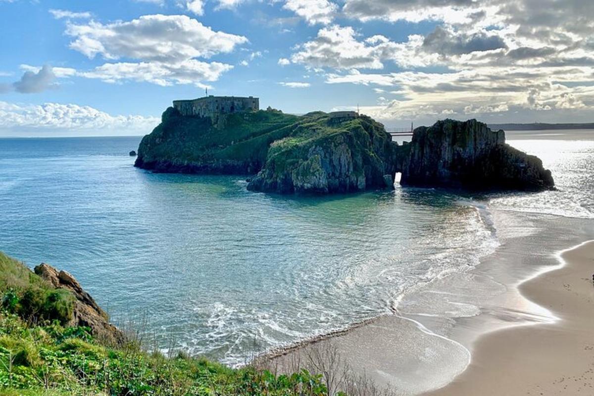 a beach with a castle on top of a cliff