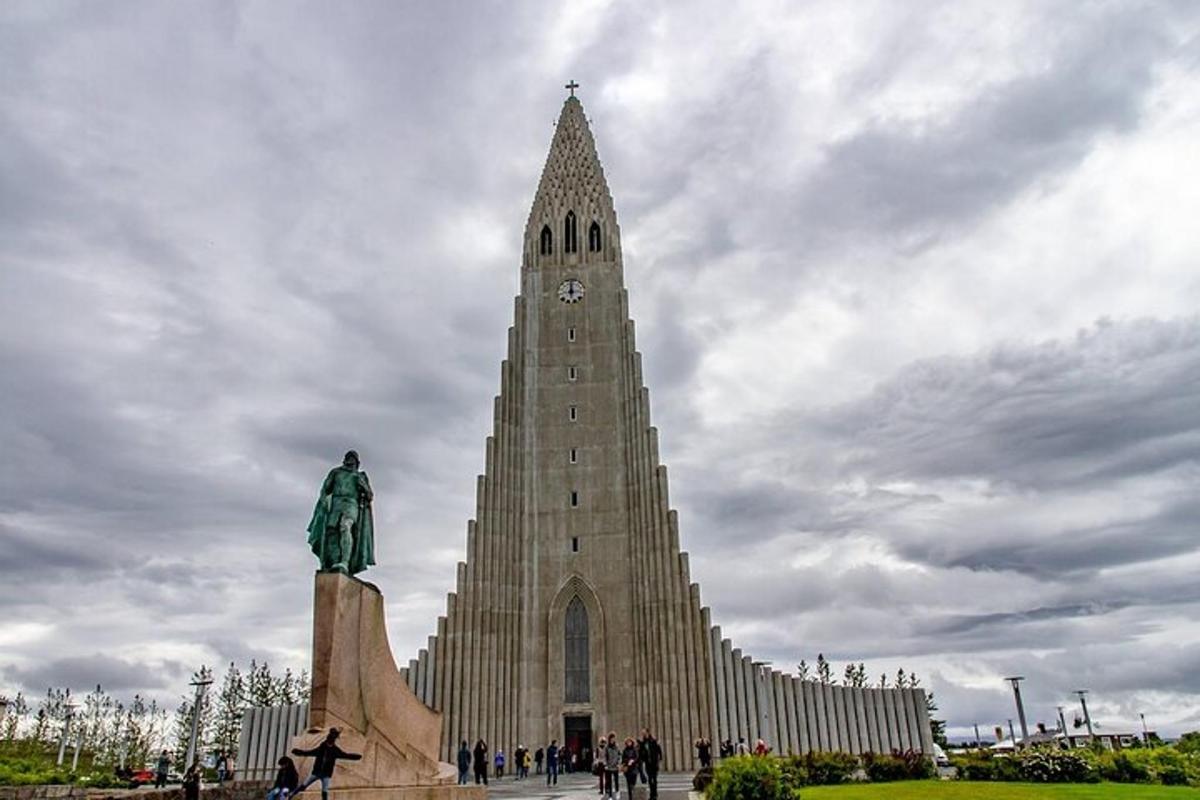 um grande edifício com uma torre do relógio com uma estátua