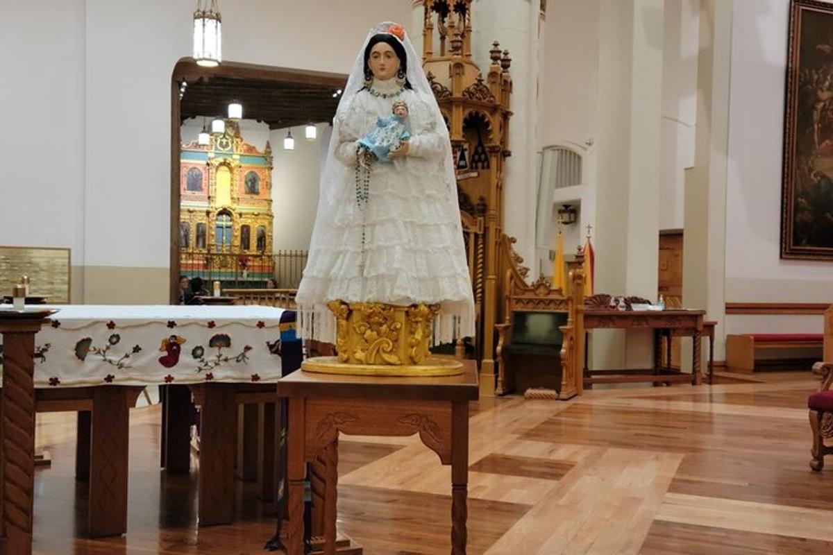 a woman in a wedding dress standing on a table in a church