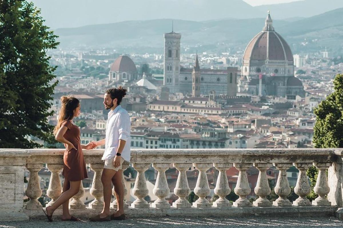 a couple standing on a ledge looking at a city