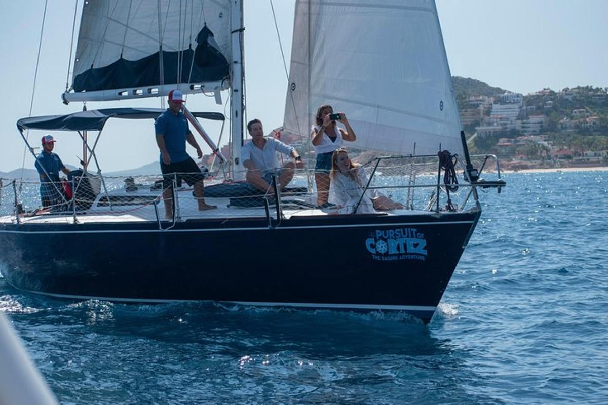 a group of people on a sail boat in the water