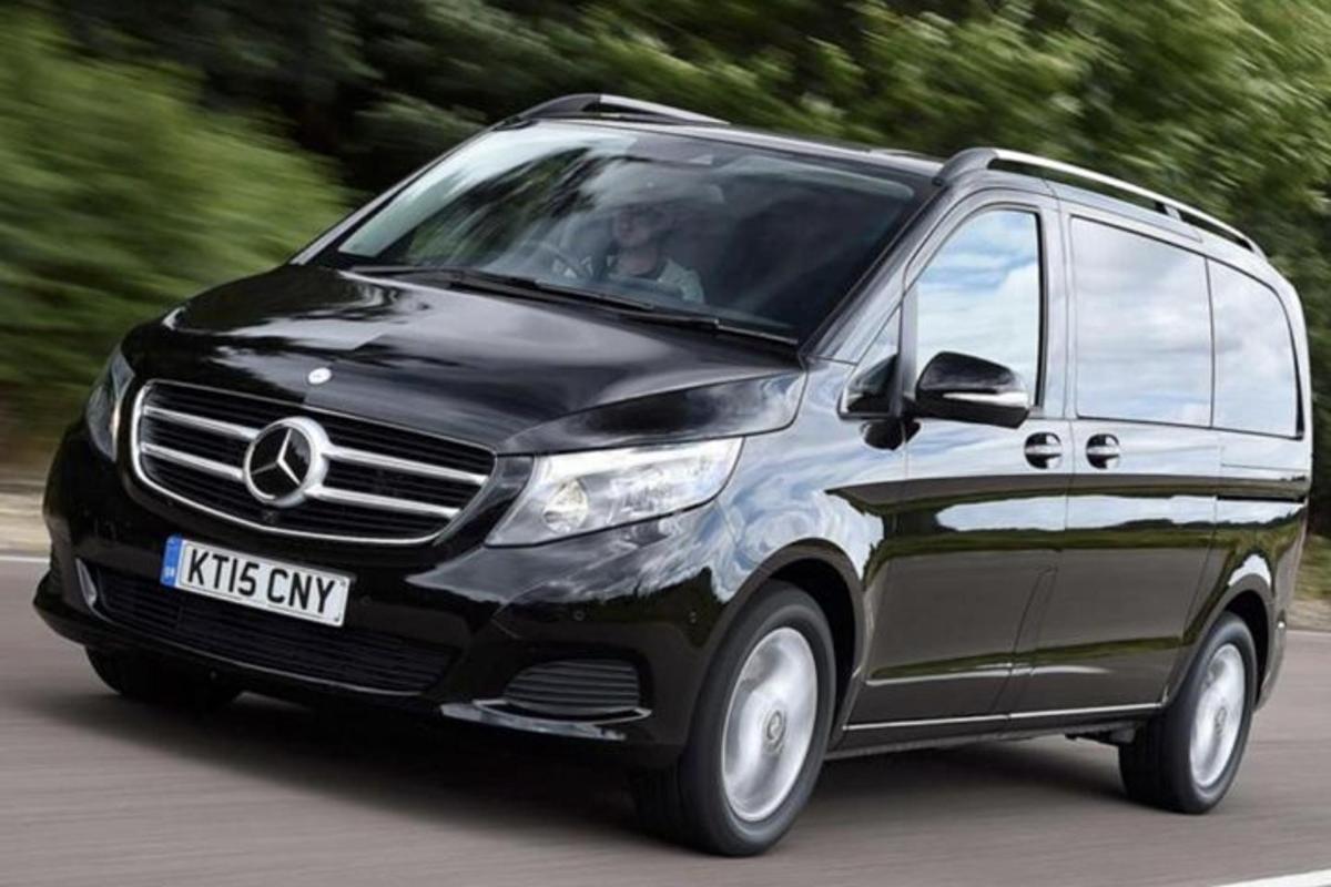 Ένα μαύρο βαν Mercedes που οδηγεί σε έναν δρόμο