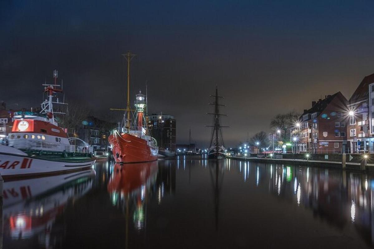 a couple of boats docked in a river at night