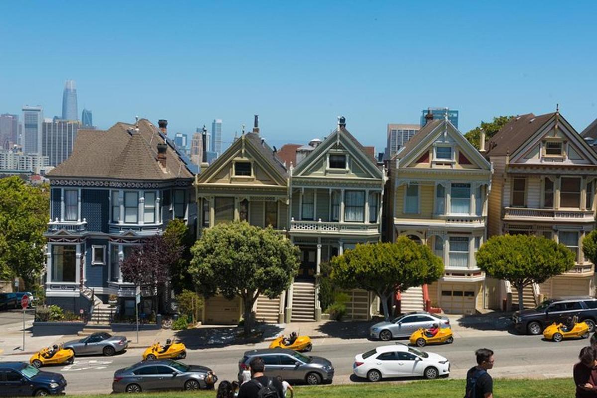a group of houses in a parking lot with cars