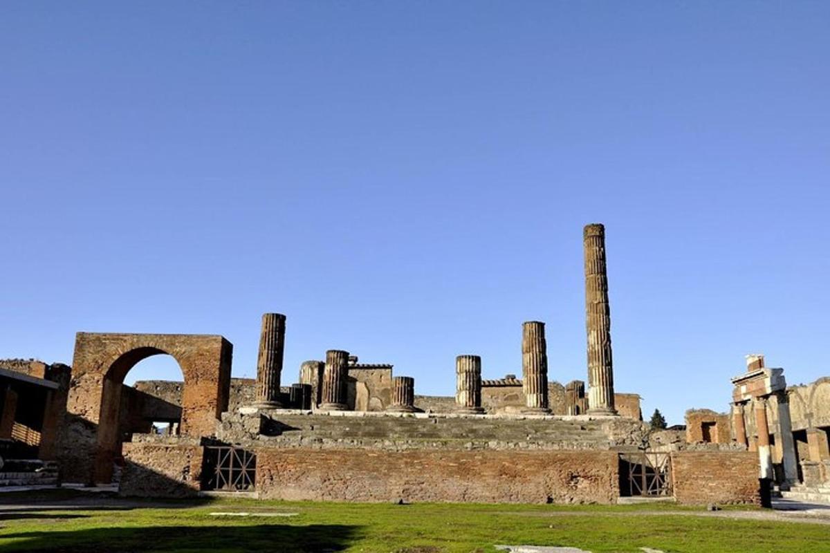 an old building with columns in a field