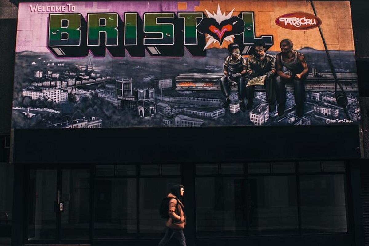 a woman walking in front of a building with a large sign