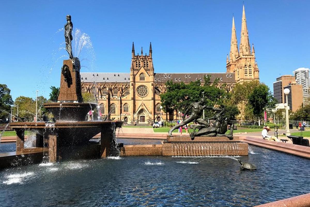 a fountain in front of a building with a cathedral