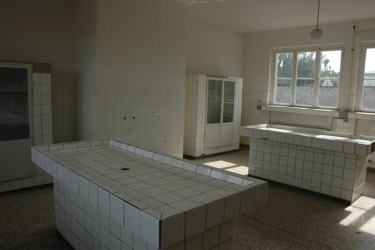 velký pokoj s bílými dlaždicemi na podlaze a okny