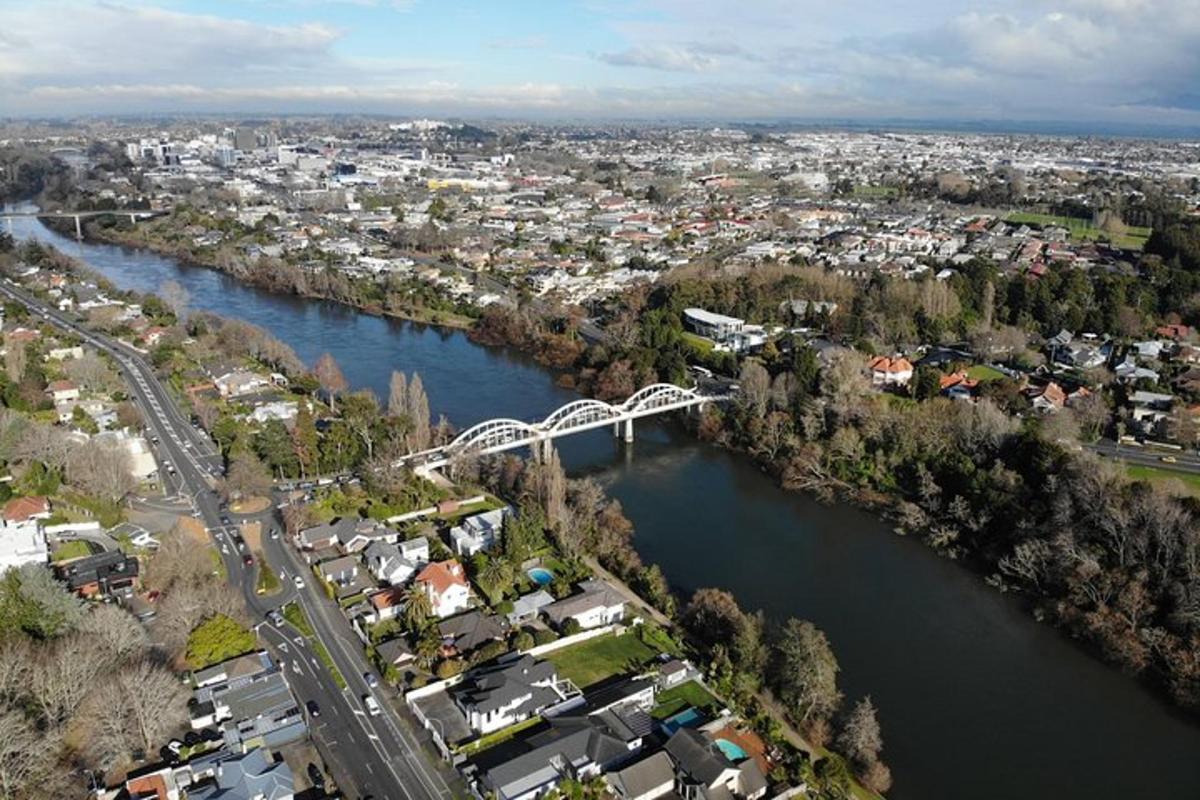 an aerial view of a river with a bridge