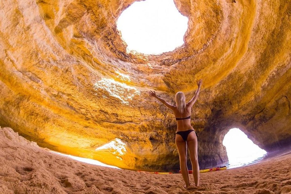 a woman in a bikini standing on a beach with her arms up