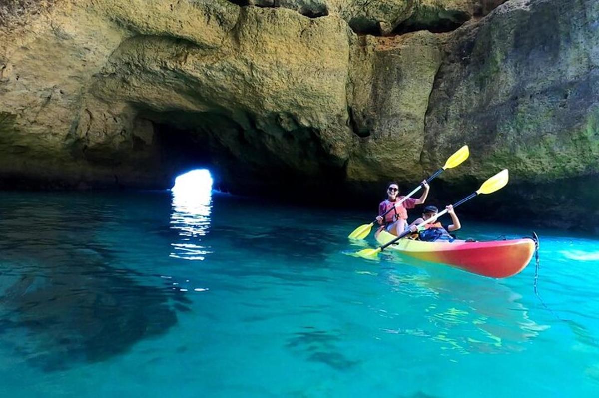 two people are in a kayak in a cave