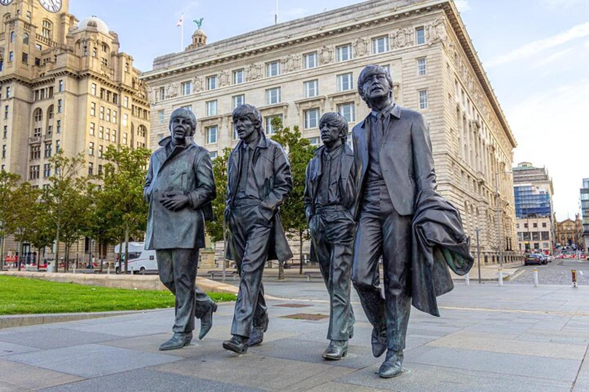 a statue of four men walking in front of a building