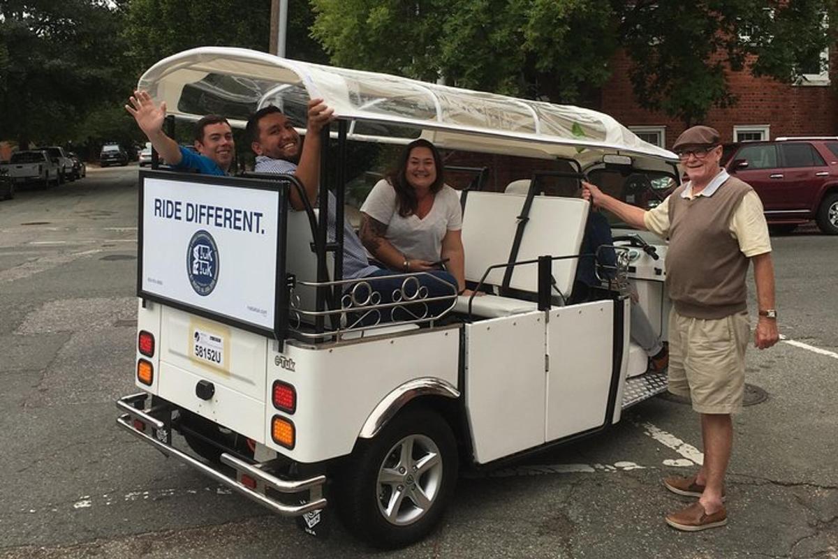 a group of people riding in a golf cart