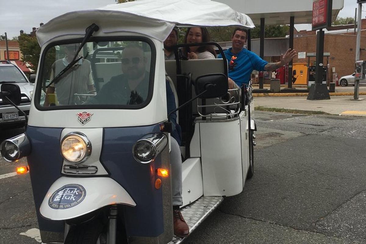 a group of people riding in a golf cart