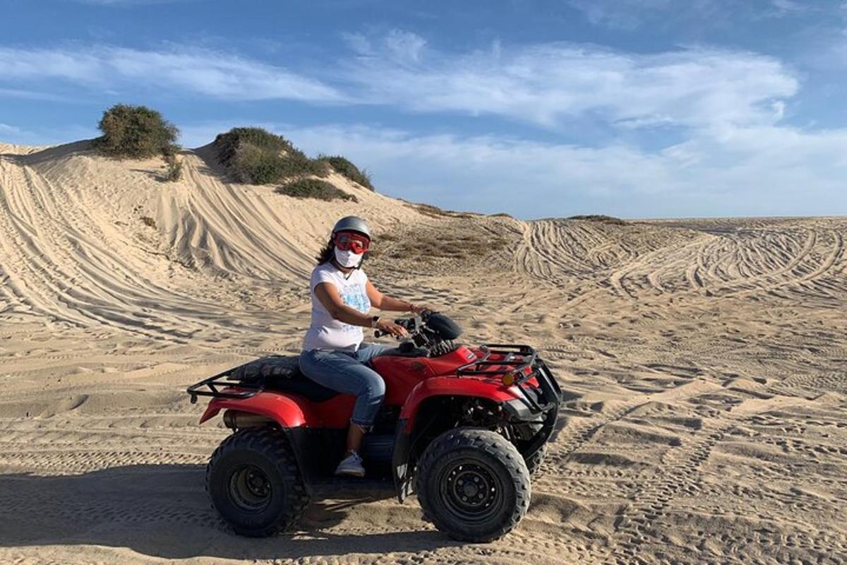 a woman riding a quad bike in the desert