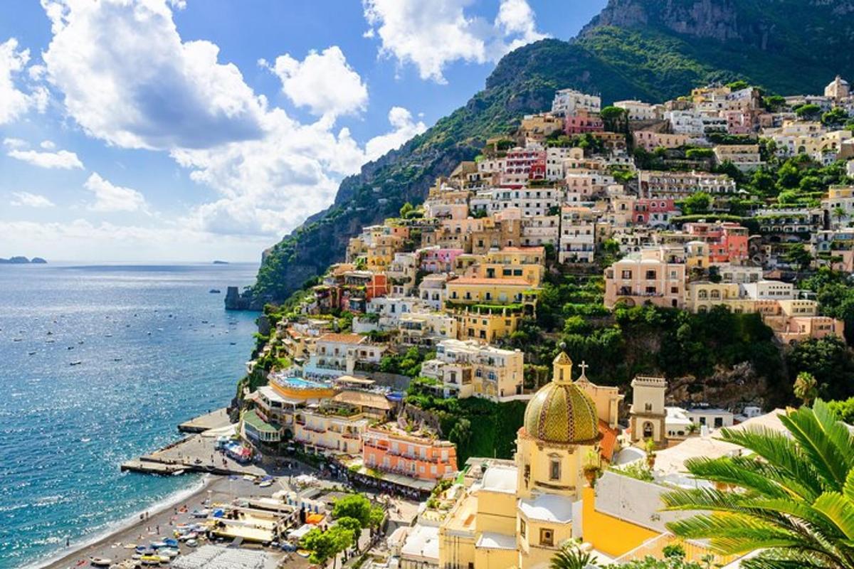 a town on a hill next to the ocean