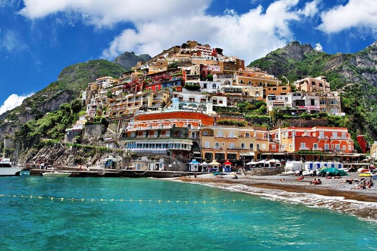 a town on top of a mountain next to a beach
