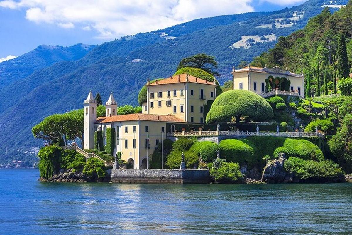 a house on a hill with a bridge in the water