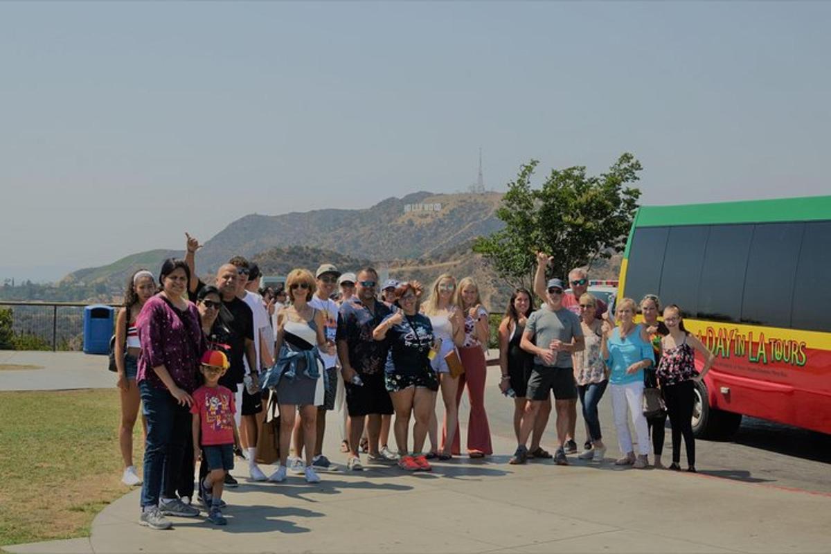 a group of people standing on a sidewalk near a bus
