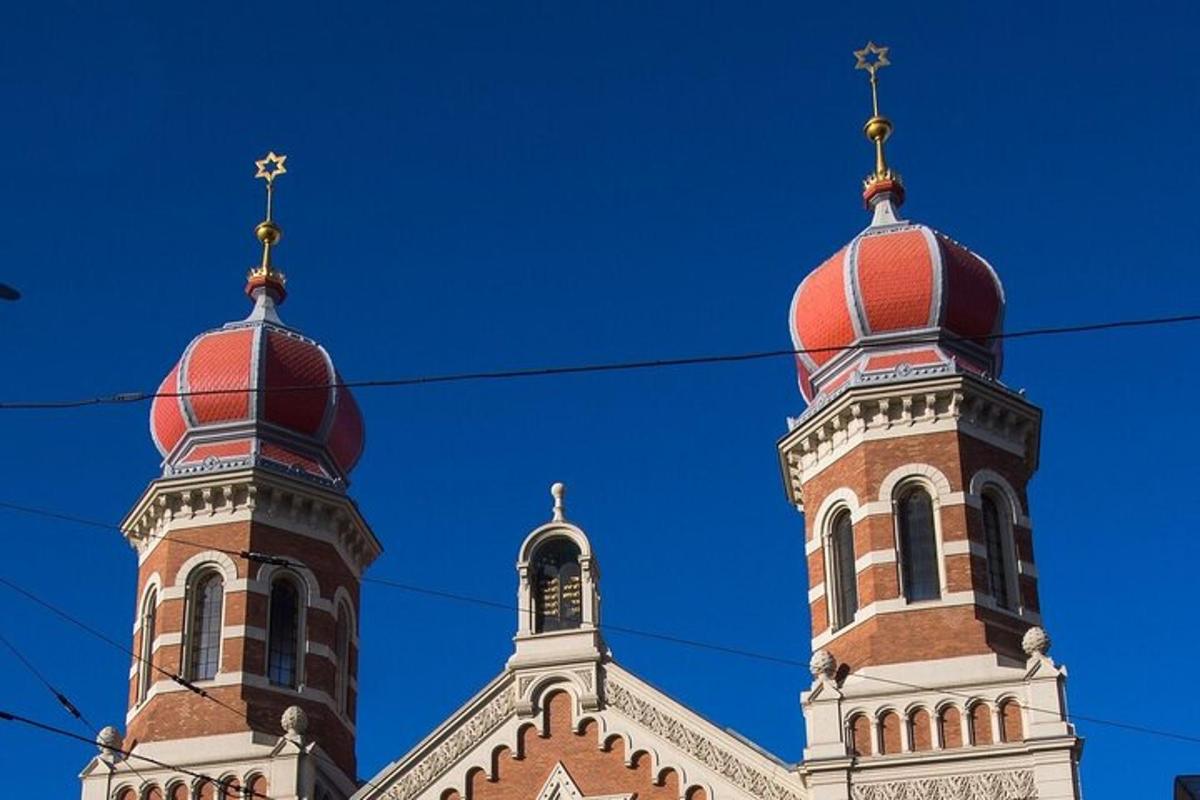 two towers on top of a building with red roofs