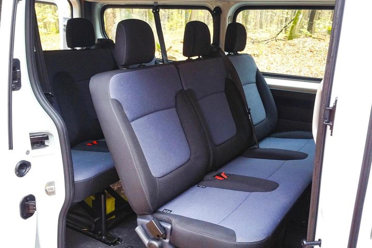 an empty back seat of a van with blue seats