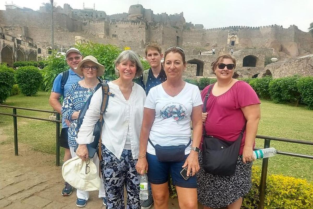 a group of people posing for a picture in front of a castle